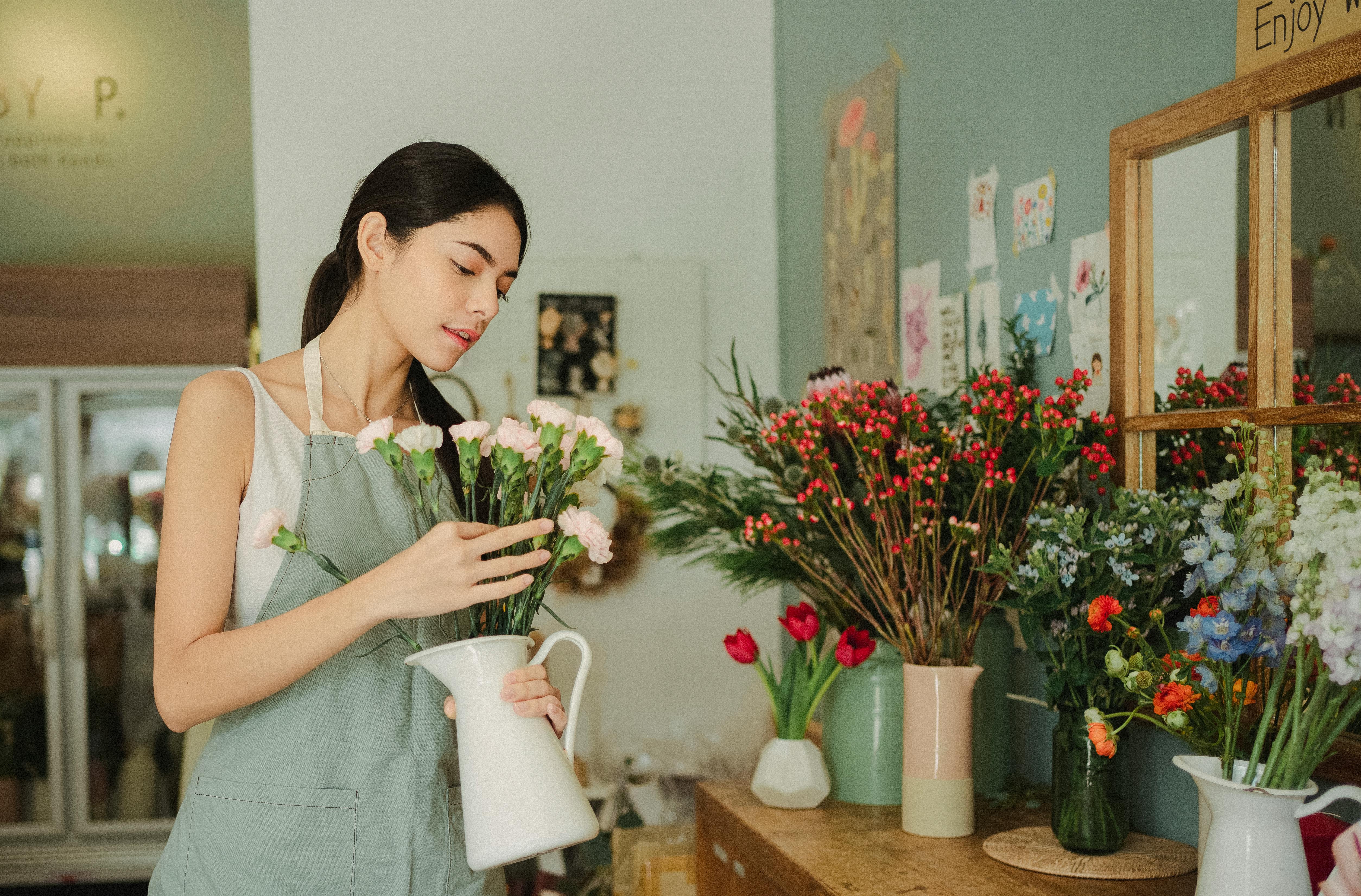 Florist arranging flowers in her shop